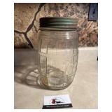 Antique glass jar with green lid