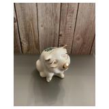 White ceramic piggy bank featuring the gold