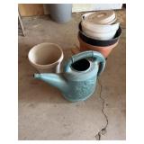 Plastic flower pots and watering can