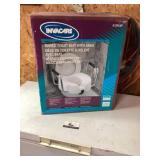 Raised toilet seat with arms, new unused