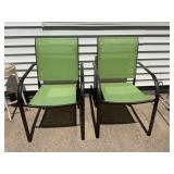 Two green patio chairs