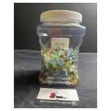 Plastic canister of marbles