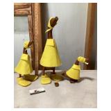 Wooden ducks with raincoats