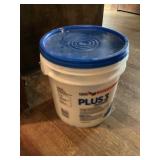 Almost full bucket of drywall mud