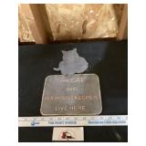 The cat and its housekeeper sign