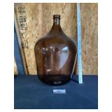 Large amber glass, demijohn vase featuring a w