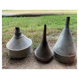 Three galvanized funnels