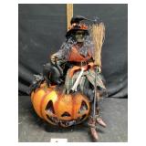 witch on lighted jack-oï¿½-lantern approximately