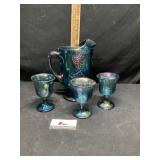 Carnival glass water, pitcher, and glasses