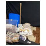 Tote of hand, sewn linens, and rugs