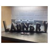 Laundry sign and bottle decor