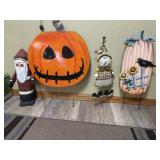 Wooden Santa and metal pumpkin and fall yard