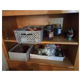 2 shelves full of candles and candle supplies