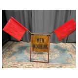 Men Working Road Sign with Caution Flags