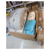 Pallet of misc home supplies pillows blankets and mystery desk or stand.