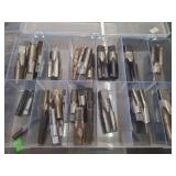 lot contains different sized  threading taps, which are cutting tools used in machining to create internal threads in pre-drilled holes, such as for nuts or threaded openings.