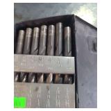 1 small metal box containing drill bits of various sizes