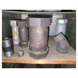 Shelf of black pipe fittings.