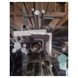 contents of shelf.  several pieces of steel, angled, solid round, solid square, round pipe,