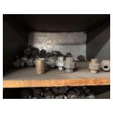 Cubby of black pipe fittings