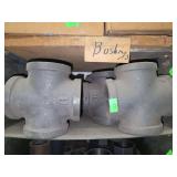 Shelf of black pipe fittings.