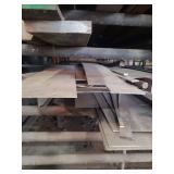 contents of shelf. several pieces of steel, solid round and square and flat sheet metal.  lengths range from rements to 8 feet.