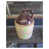 lot contains 1 vintage stoneware whiskey jug.