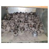 Shelf of black pipe fittings.