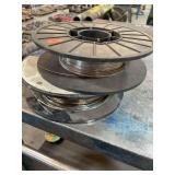 Two partial rolls of .30” welding wire.