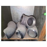 Shelf of black pipe fittings.