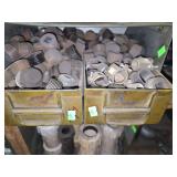 Shelf of black pipe fittings.