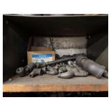 Cubby of black pipe fittings