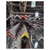 contents of shelf.  several pieces of different sized angled steel . lengths range from 4ft to 20 ft.