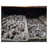 Shelf of black pipe fittings.