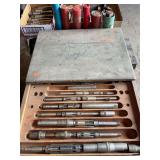 Expandable reaming bit set in wood box.