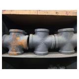 Shelf of black pipe fittings.