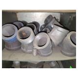Shelf of black pipe fittings.