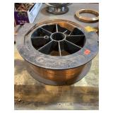 Large partial roll of unknown welding wire.