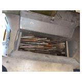 metal toolbox filled with various chisels