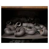 Cubby of black pipe fittings