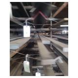 contents of shelf.  several pieces of steel, angled,  solid square. lengths range from 15 to 20 feet