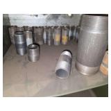 Shelf of black/ galvanized pipe fittings