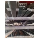 contents of shelf.  several pieces of angled aluminum,  round galvanized pipe, and square steel ranging in size from 5ft to 20 ft