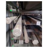 contents of shelf. several pieces solid square steel,  solid round steel, angled steel and steel. lengths range from 4 to 8 feet