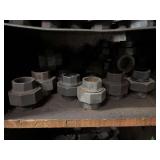 Cubby of black pipe fittings