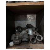Cubby of black pipe fittings