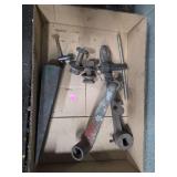 collection of antique cast iron hand tools, likely parts for a blacksmith drill press or a vintage screw jack.