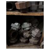 Cubby of black pipe fittings