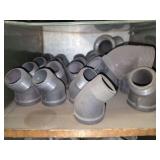 Shelf of black pipe fittings.