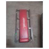 a automotive mechanic's creeper, branded 'pronto.' missing 1 wheel